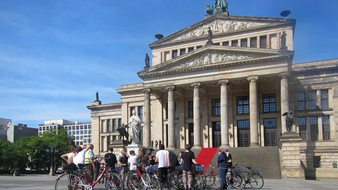 Cyclists gather in front of Berlin's Konzerthaus during a guided bike tour.