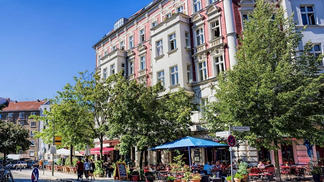 Berlin street scene with outdoor cafes and historic buildings on a guided bike tour route.