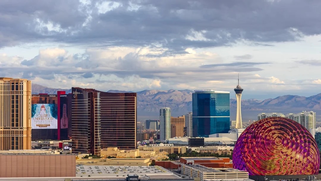 Las Vegas skyline with Stratosphere Tower and colorful dome structure.