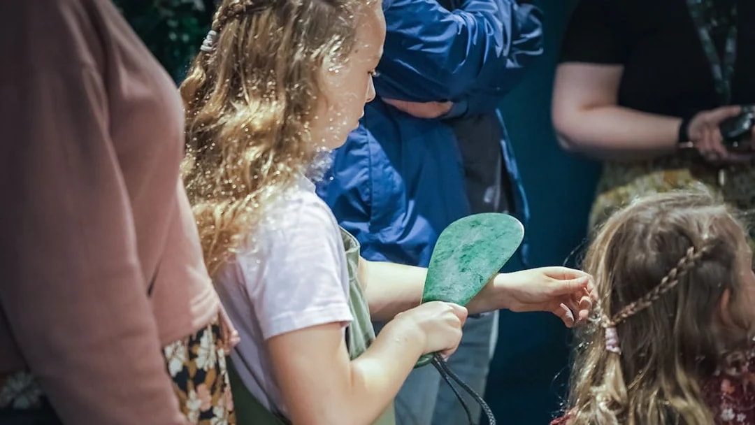 Child holding jade artifact during Mountain Jade Highlights Tour.