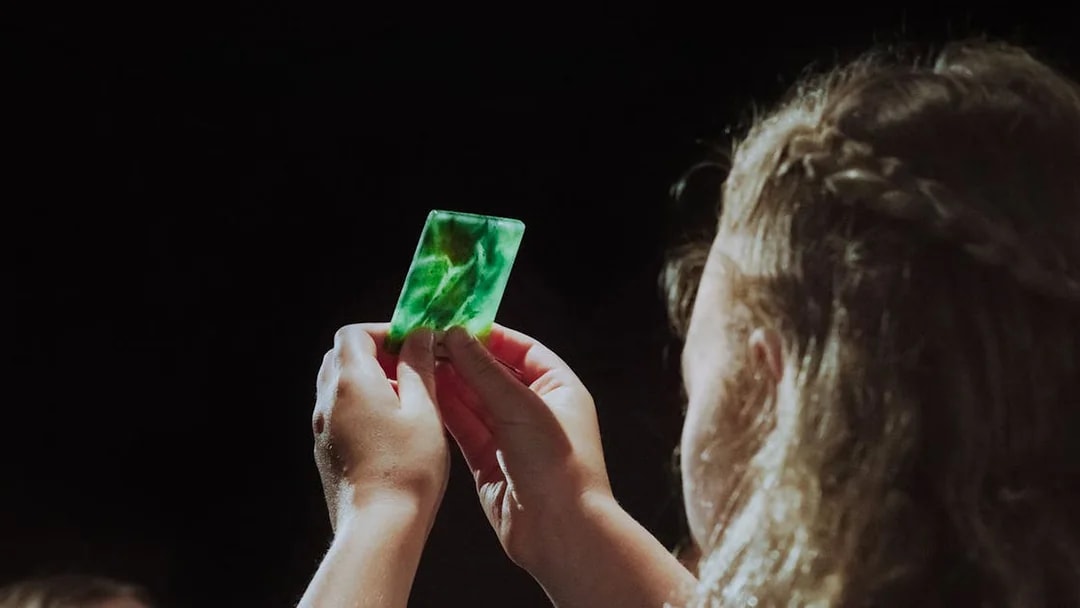 Person examining a piece of jade during the Mountain Jade Highlights Tour.