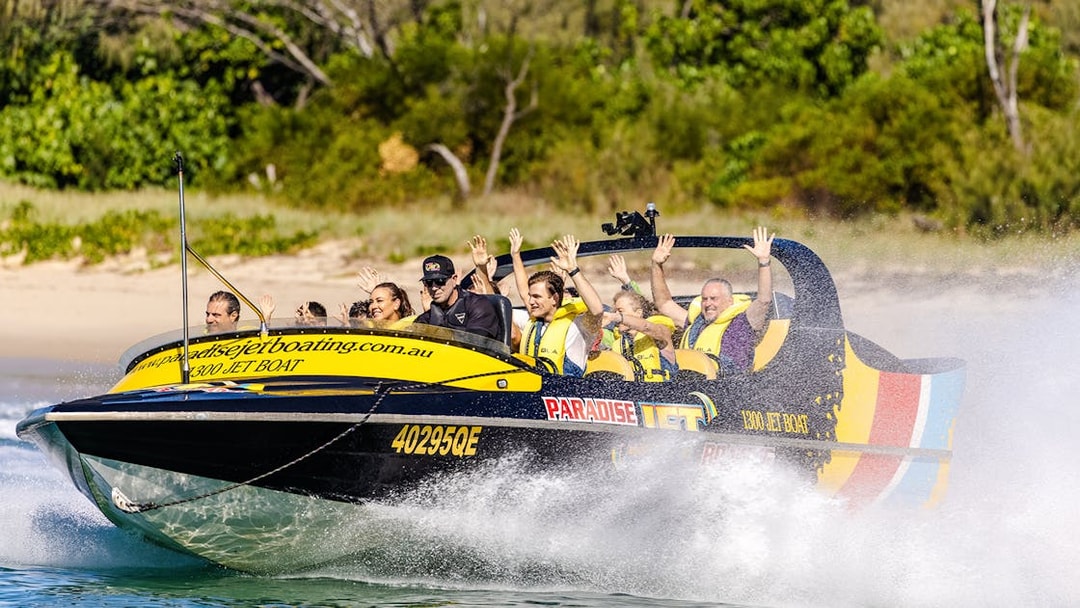 Jet boat with passengers enjoying a thrilling ride on Gold Coast waters.