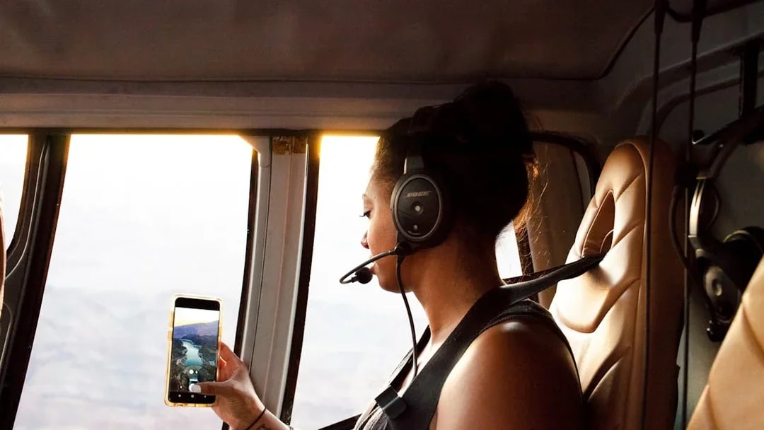Guest viewing Grand Canyon from airplane window on South Rim tour.