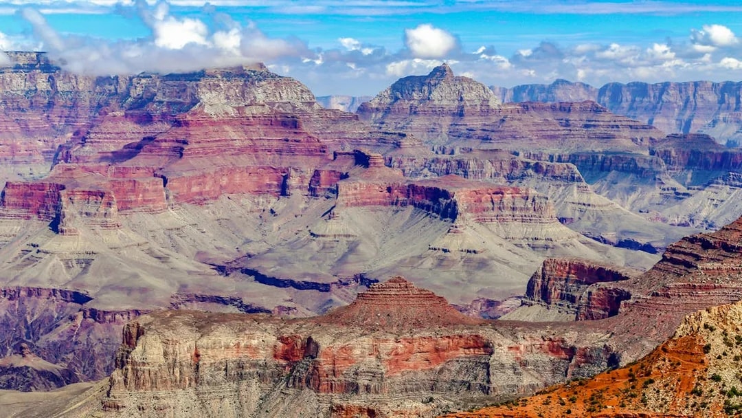 Grand Canyon's layered rock formations under a clear blue sky.