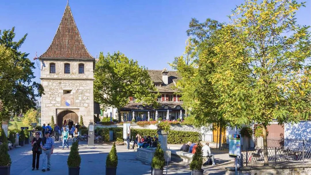Laufen Castle entrance with visitors, part of the 4-hour guided tour from Zürich to Rhine Falls.