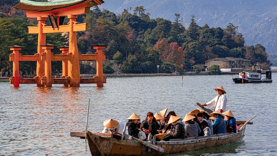 Boat tour near Itsukushima Shrine's torii gate, Hiroshima, Japan.