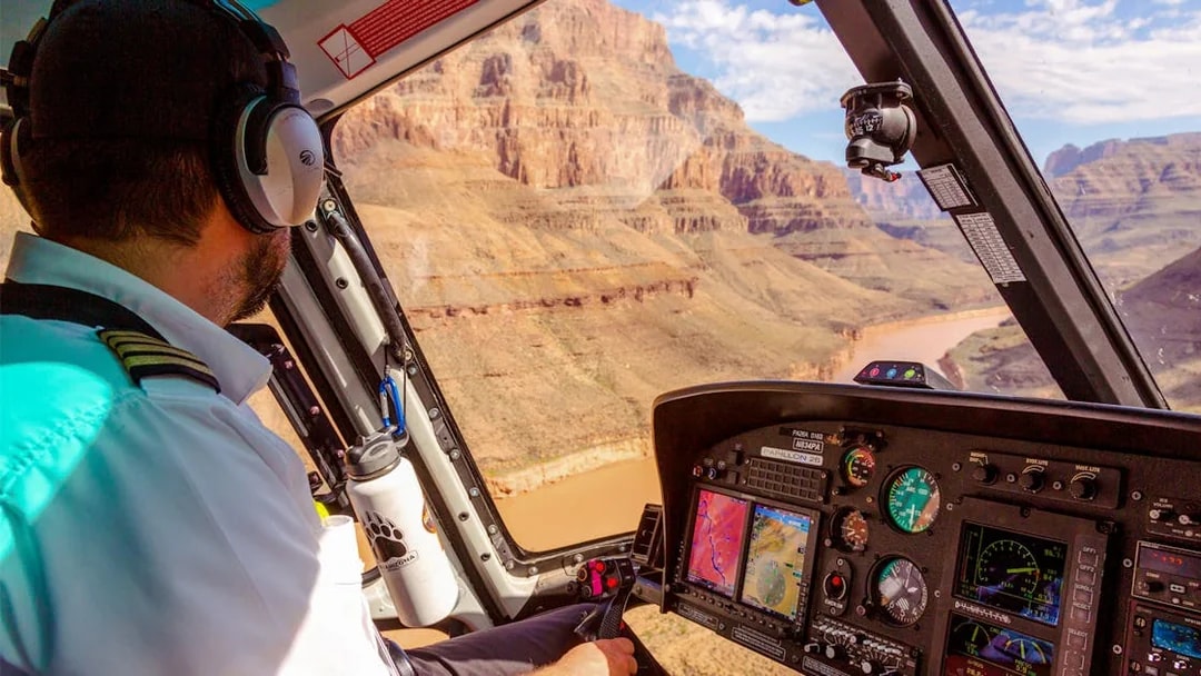 Helicopter pilot flying over Grand Canyon during Las Vegas to Grand Canyon West tour.