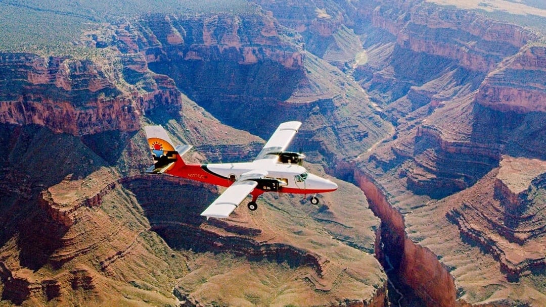 Aircraft flying over the Grand Canyon, showcasing the vast canyon landscape.