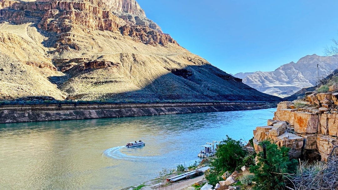 Helicopter view of Colorado River with boat at Grand Canyon West Rim.