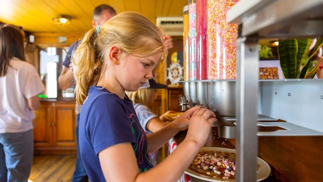 Guests adding toppings to pancakes on a cruise in Rotterdam.