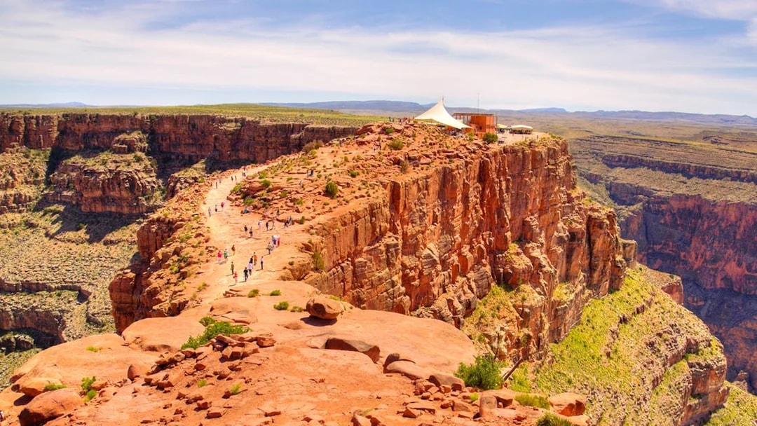 Visitors walking along the rocky path at Guano Point, Grand Canyon West Rim.