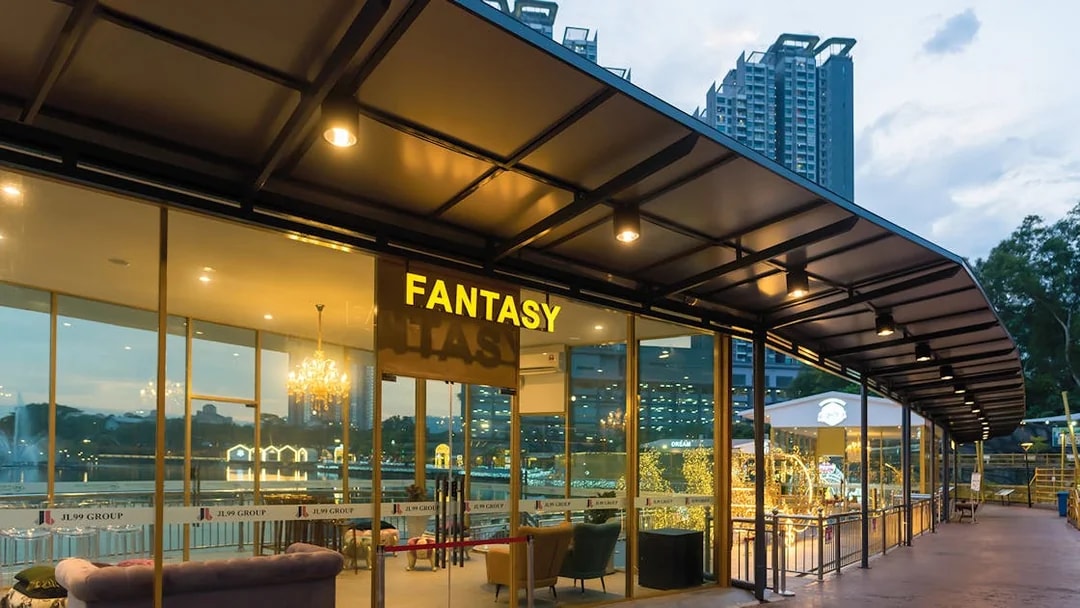 Entrance to Fantasy Hall at 99 Wonderland Park, Kuala Lumpur, with city skyline in background.