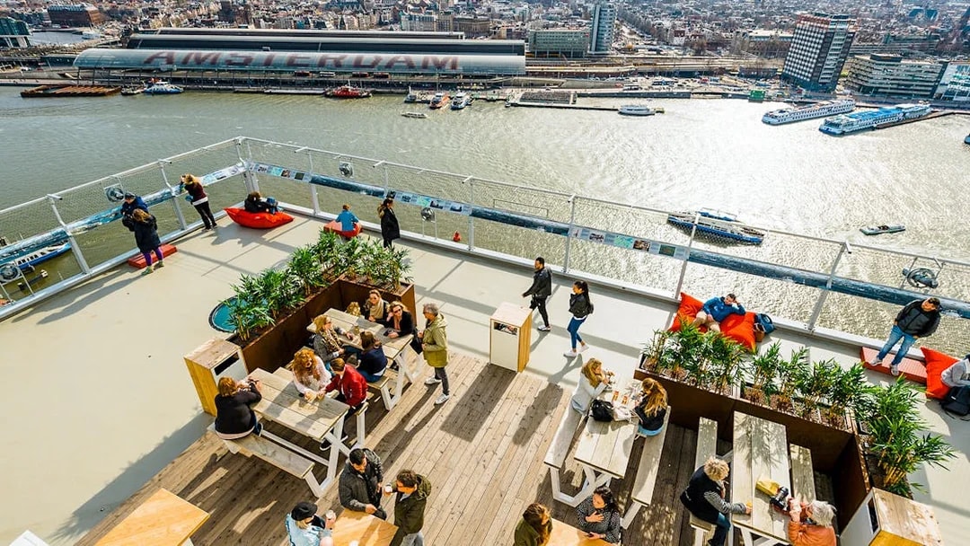 Visitors enjoying the view from ADAM Lookout panorama deck in Amsterdam.
