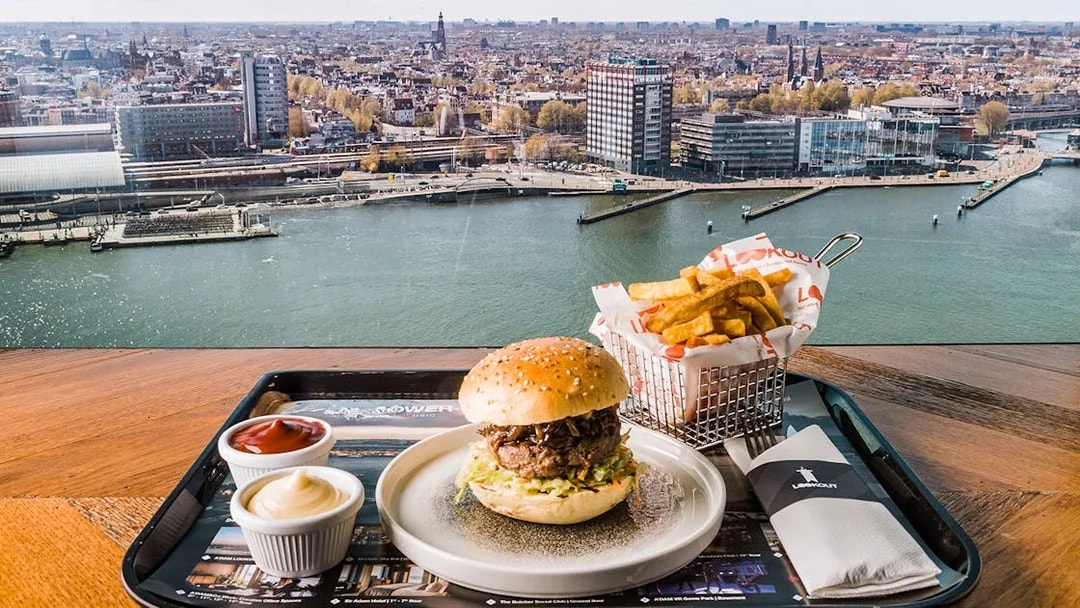 ADAM Lookout view with burger and fries at Panorama Restaurant, Amsterdam.