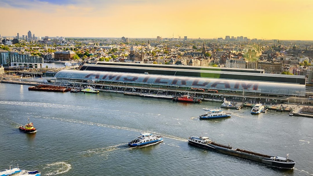 Amsterdam cityscape view from Lookout with boats on the IJ River.