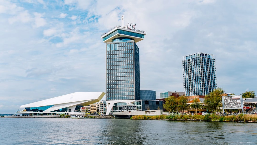Adam Tower and surrounding buildings by the waterfront in Amsterdam.