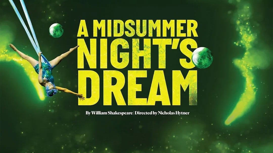 Aerial performer in "A Midsummer Night's Dream" with green backdrop.