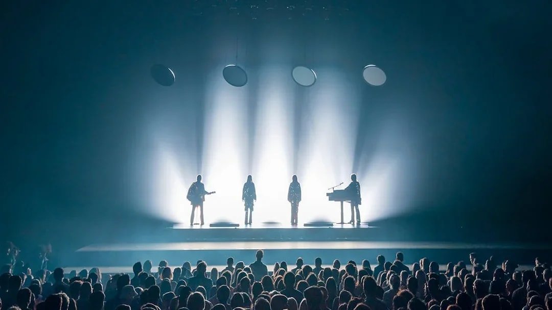 ABBA Voyage concert stage with band silhouettes and audience in London.