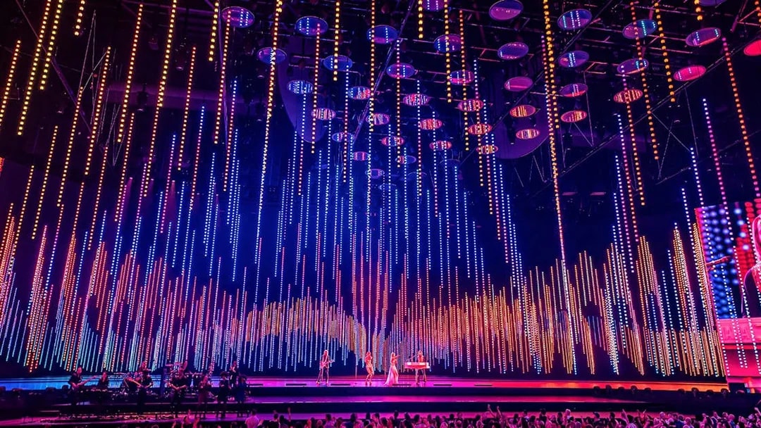 ABBA Voyage concert stage with colorful light display in London.