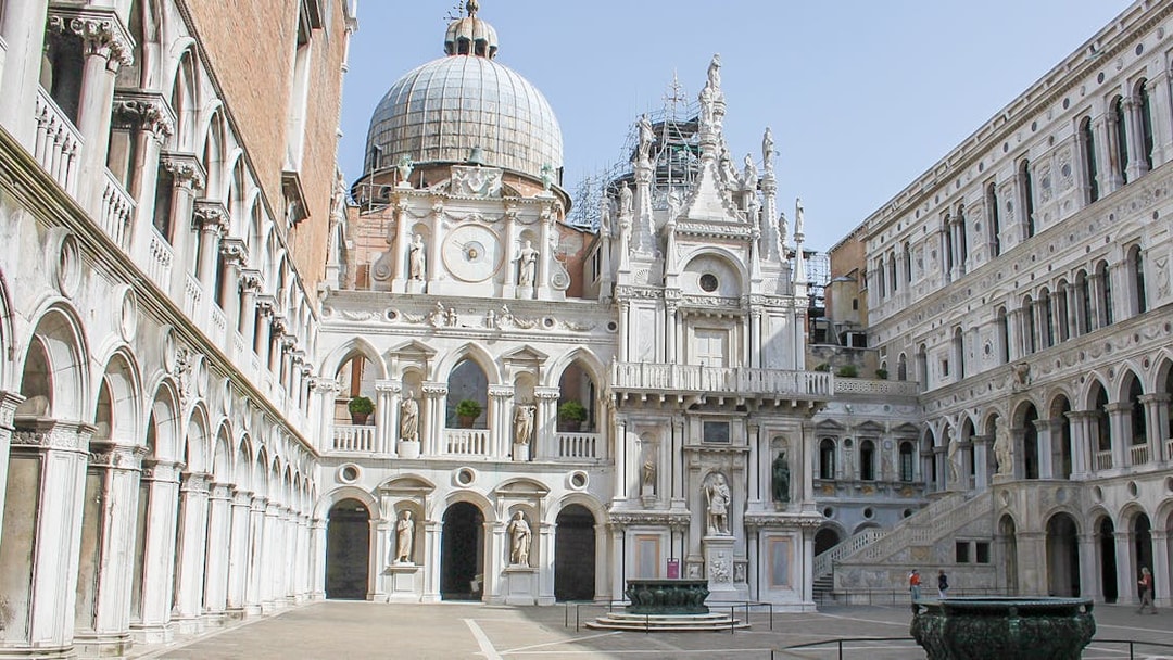 Courtyard of Doge's Palace, Venice, featuring ornate architecture and statues.