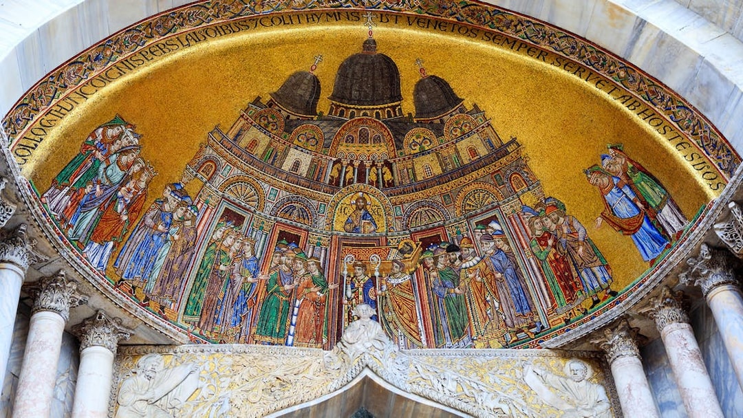 Mosaic detail of St Mark's Basilica in Venice, featuring religious figures and intricate designs.