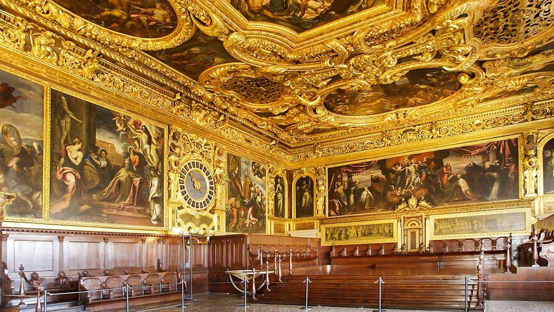 Doge's Palace interior with ornate gold ceiling and historic paintings, Venice walking tour.