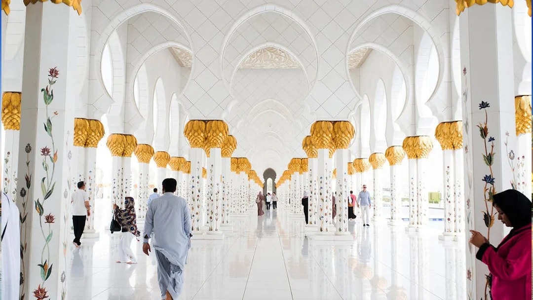 Abu Dhabi Mosque interior with ornate columns during guided tour from Dubai.
