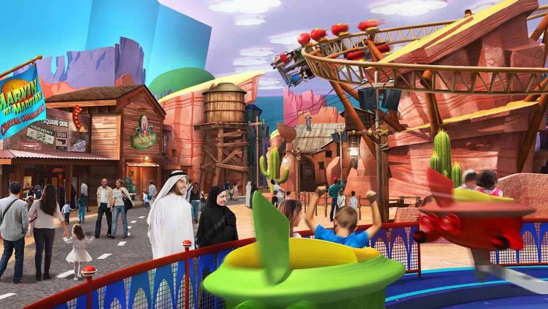 Warner Bros. theme park with families enjoying rides and attractions in Abu Dhabi.