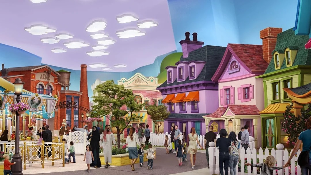 Visitors exploring Warner Bros. themed area with colorful buildings in Abu Dhabi.