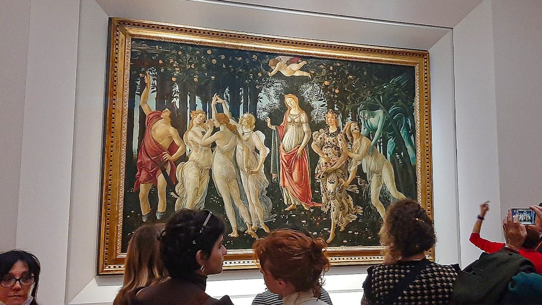 Visitors viewing Botticelli's "Primavera" at Uffizi Gallery, Florence.