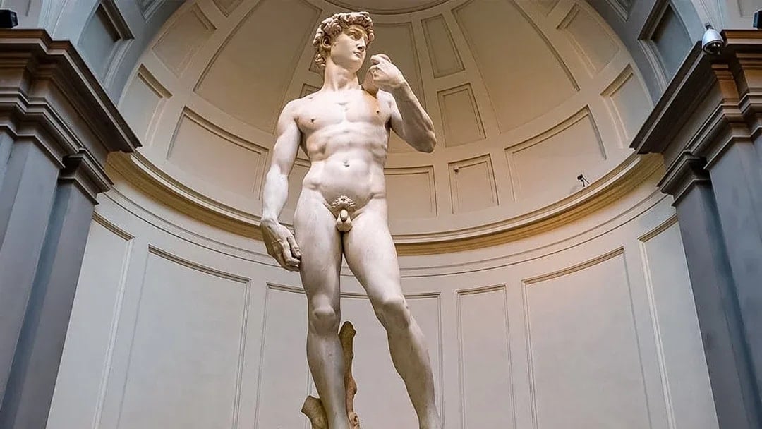 Statue of David at Accademia Gallery, Florence, viewed by tourists with reserved tickets.
