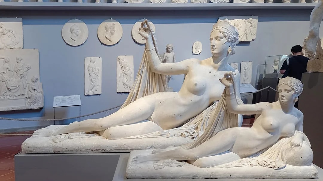 Sculptures in Accademia Gallery, Florence, Italy, with classical figures in reclining poses.