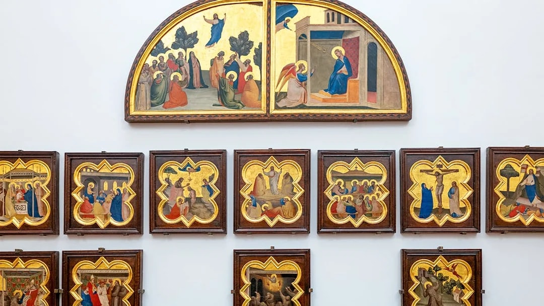 Accademia Gallery art display in Florence, Italy, featuring religious paintings with timed entry tickets.