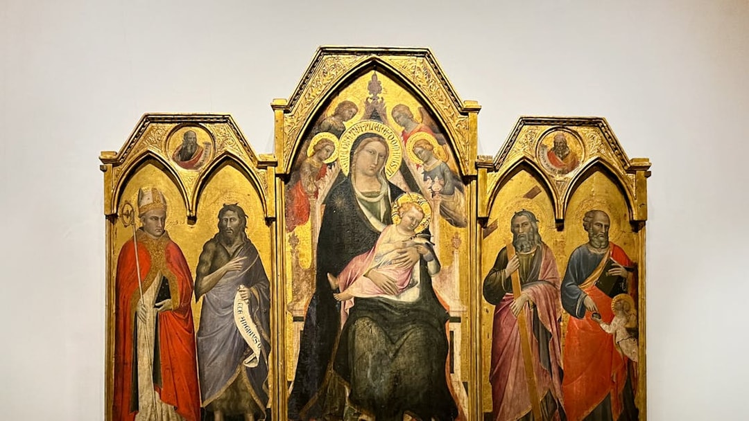 The Enthroned Madonna and Child with Saints by Agnolo Gaddi, featuring religious figures.