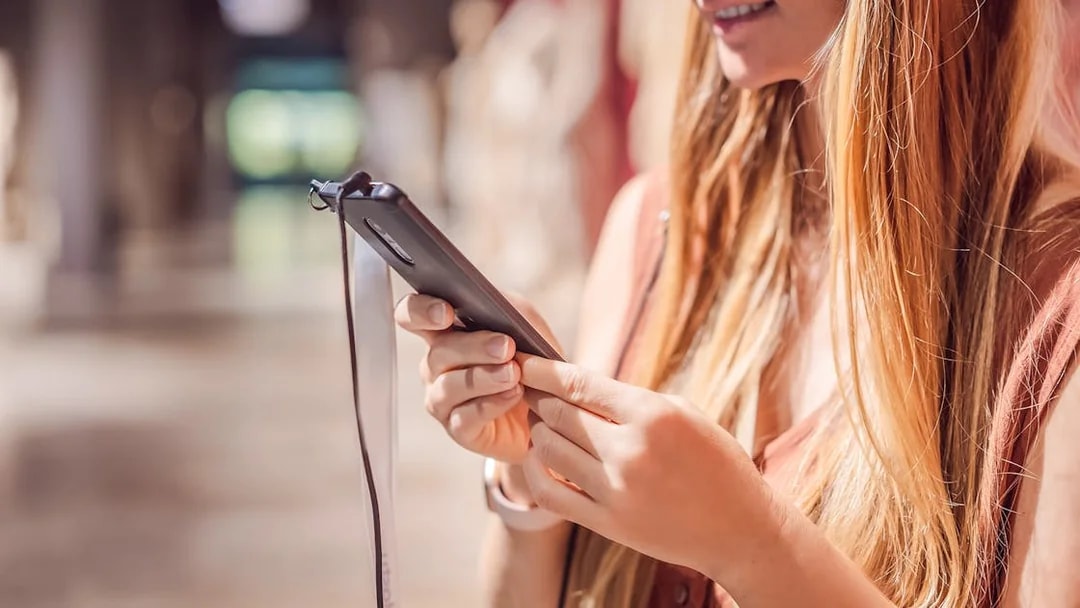 Woman using phone audio guide in a museum.