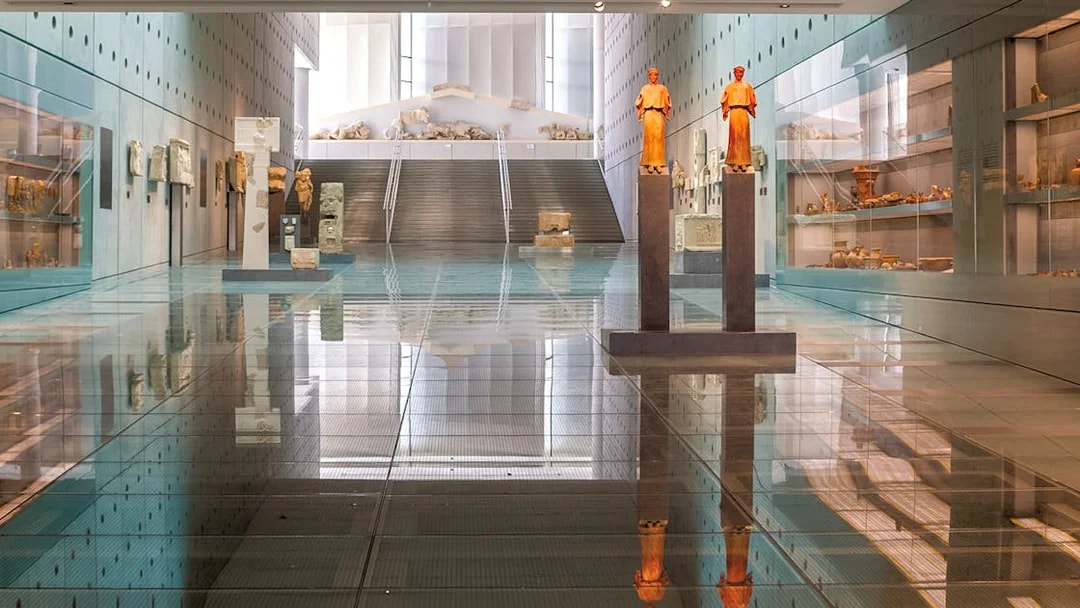 Acropolis Museum interior with ancient statues and artifacts on display.