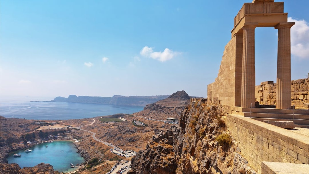Acropolis of Lindos overlooking the sea with ancient ruins and coastal landscape.