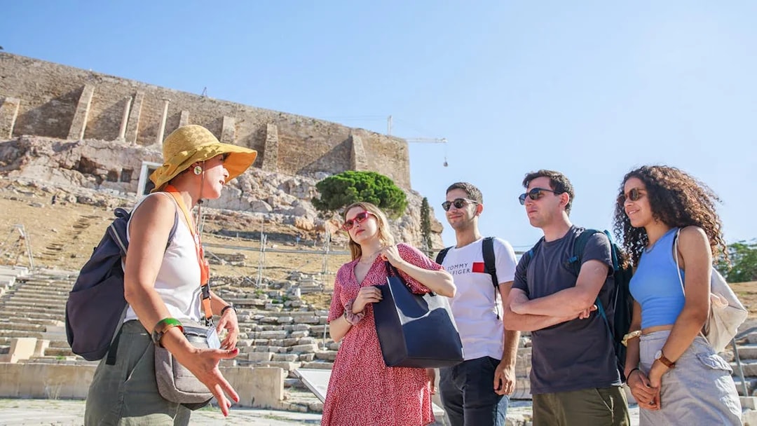 Tour guide explaining citadel ruins to group in Athens.