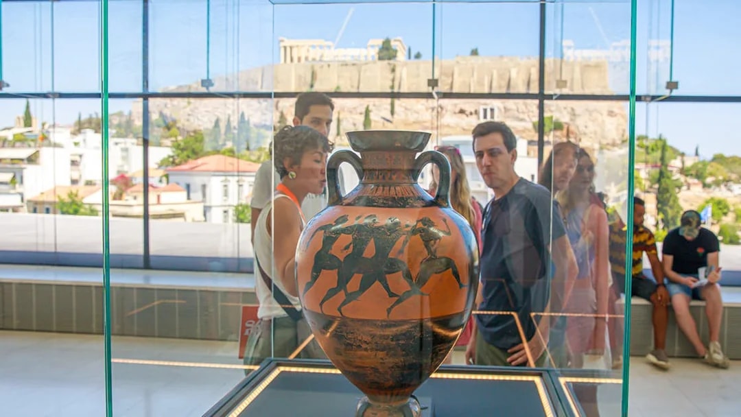 Ancient Greek vase in Acropolis Museum with Parthenon view in Athens.