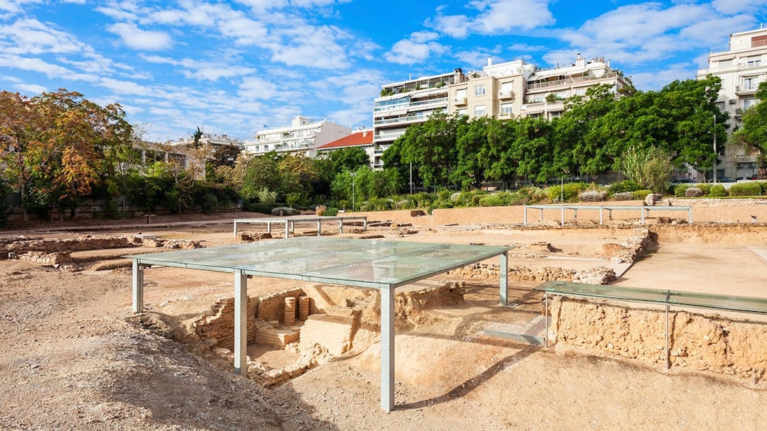 Archaeological site of Aristotle's School with modern buildings in the background, Athens, Greece.