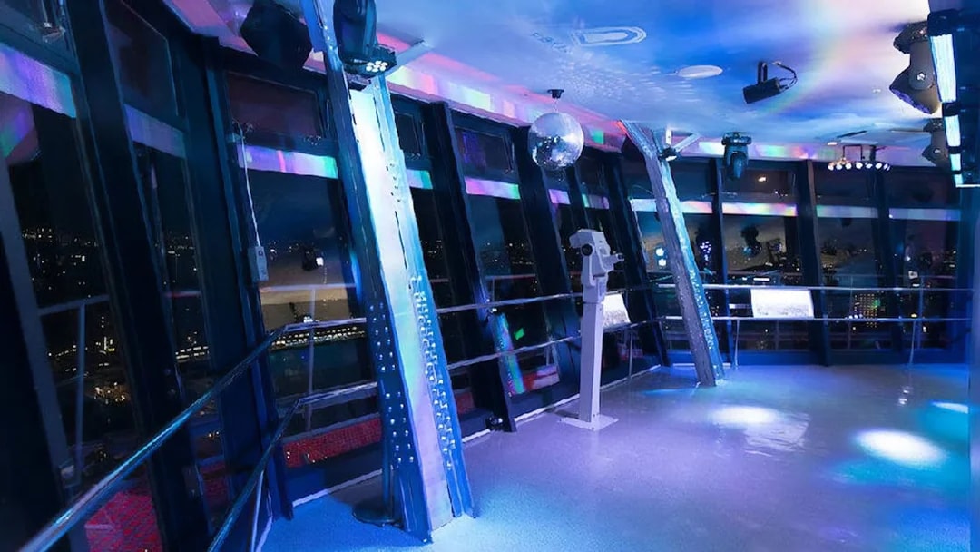 Observation deck inside Tsutenkaku Tower with city views at night.