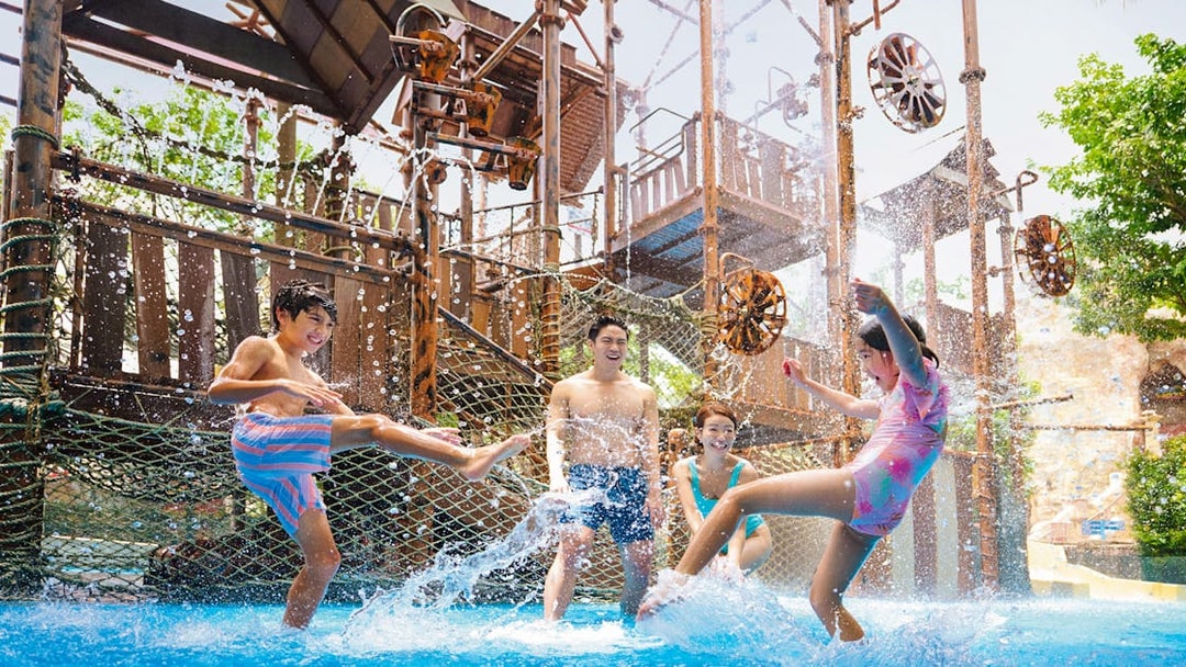 Visitors enjoying water play at Adventure Cove Waterpark™ with interactive structures.