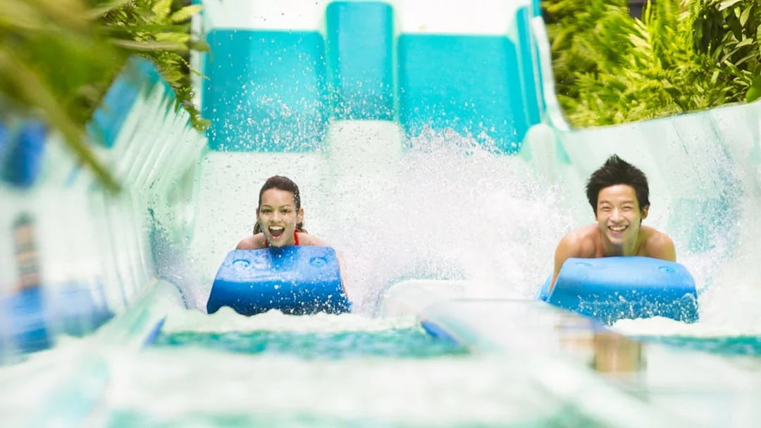 Riders enjoying a water slide at Adventure Cove Waterpark™‎.