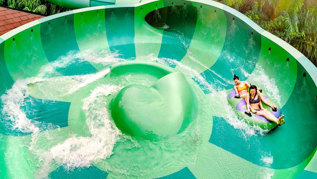Visitors enjoying a water slide at Adventure Cove Waterpark™.