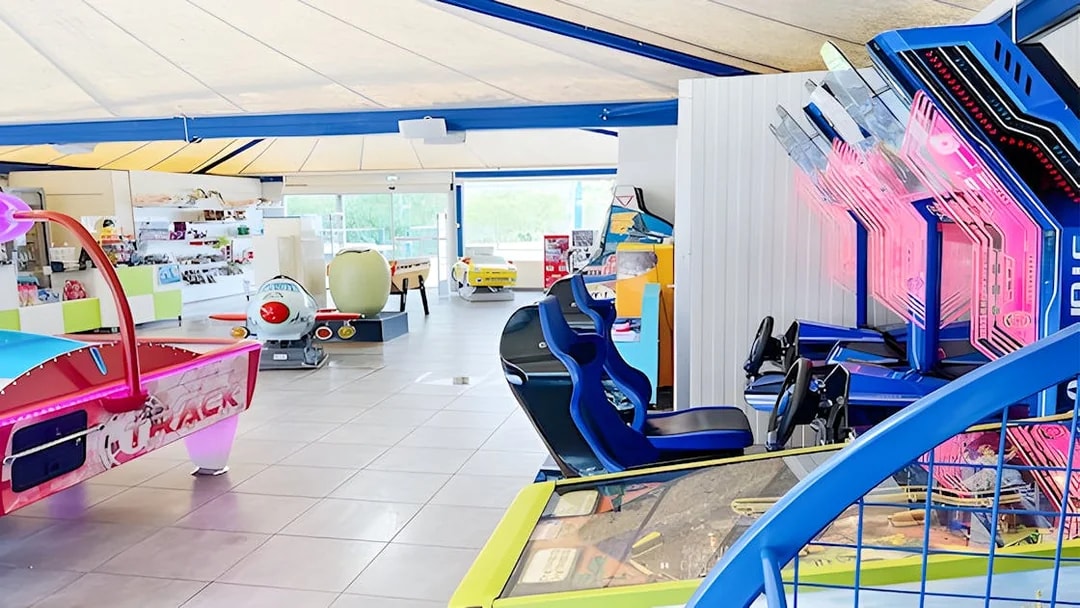 Arcade game room with racing simulators and air hockey table at Adventure Golf.