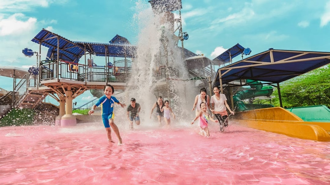 Tourists enjoying pink water pool at Adventure Waterpark Desaru Coast.