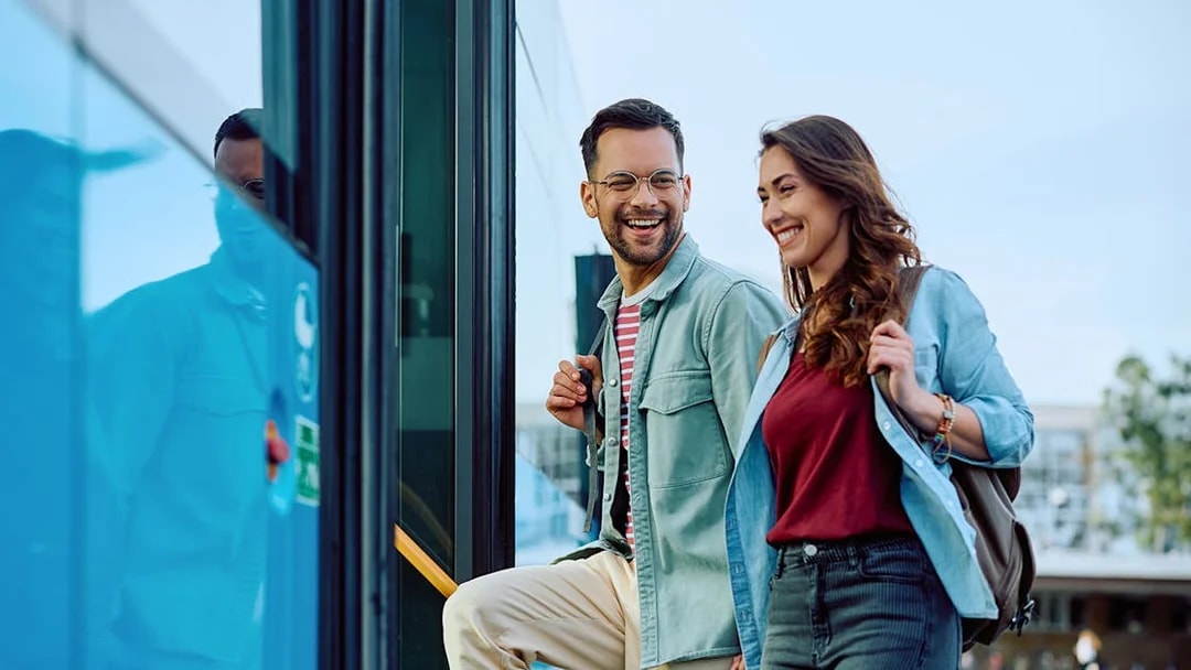 Couple boarding Aerobus in Barcelona city center for airport transfer.