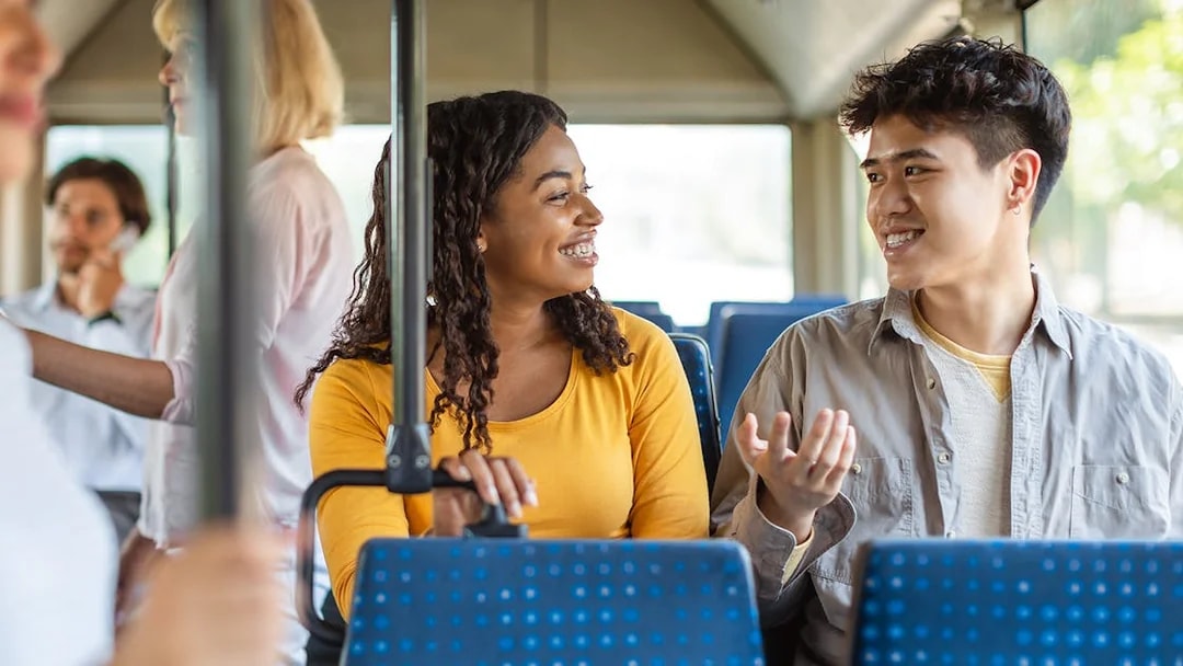 People chatting inside Aerobus traveling to Barcelona city center.