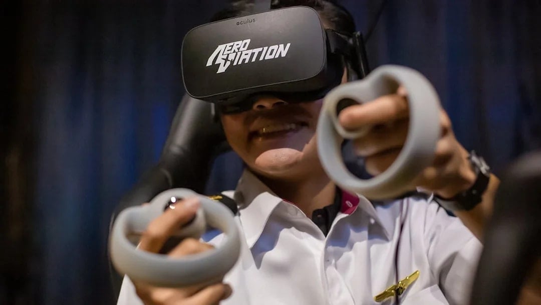 Person using virtual reality headset and controllers at Aeroviation flight experience.
