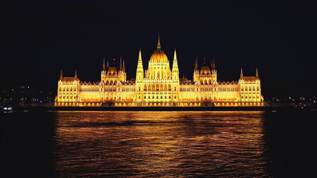Illuminated Parliament Building at night, Bucharest sightseeing tour.